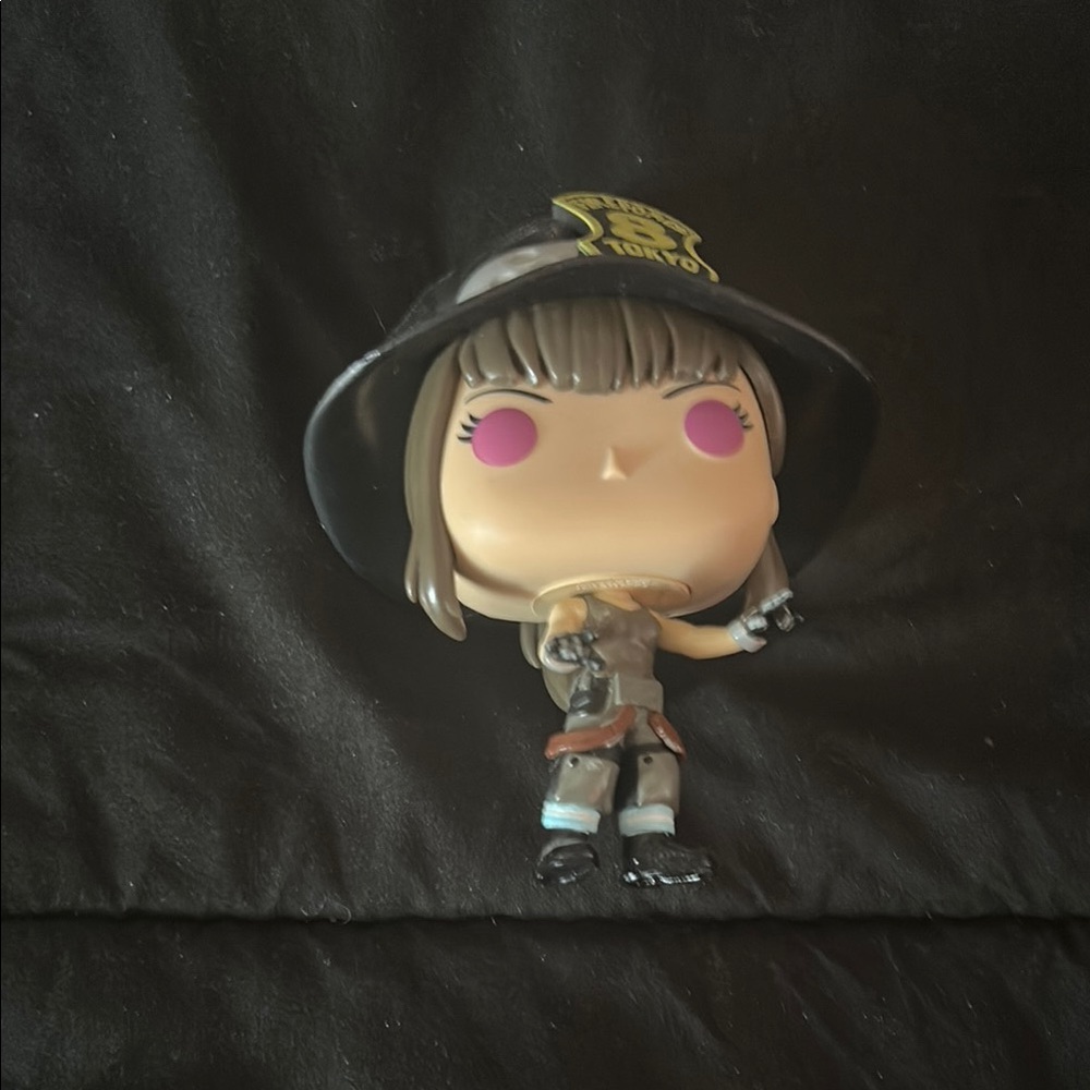 Funko Pop with Black Hat and Pink Eyes